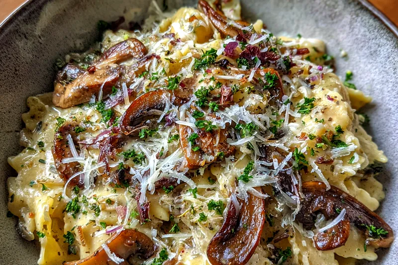 Ingredients for Leek Mushroom Gruyere Pasta arranged on a wooden countertop.