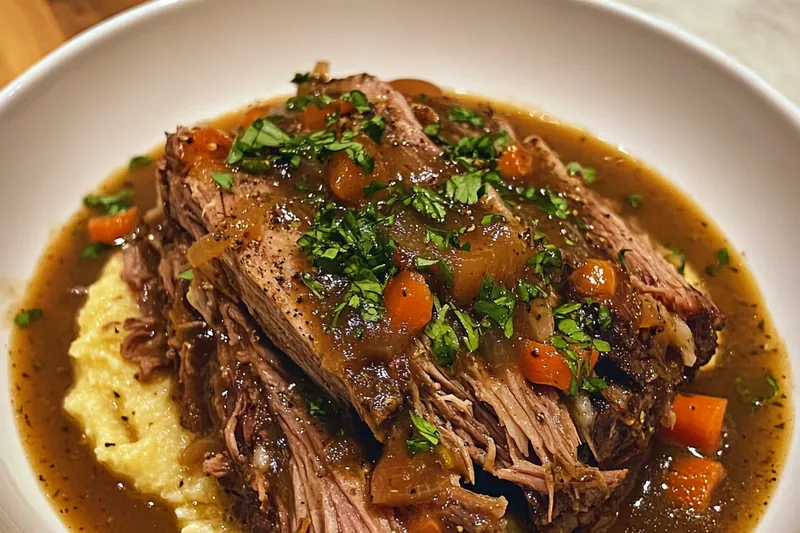 A pot of Classic Italian Pot Roast simmering on the stove, filled with tender beef and vegetables.
