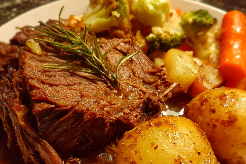Cooking pot roast with vegetables in a Dutch oven