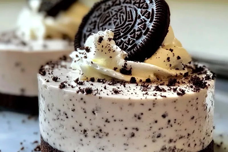 Step-by-step process showing Oreo crust being pressed into glasses, cream cheese mixture being prepared, and final assembly