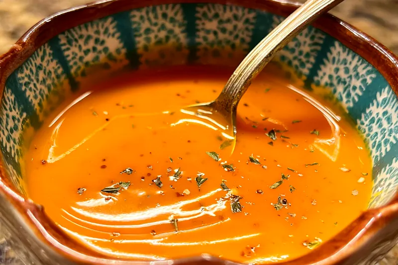 Ingredients for yum yum orange sauce laid out including mayonnaise, fresh orange, ketchup, spices, and seasonings on a clean counter